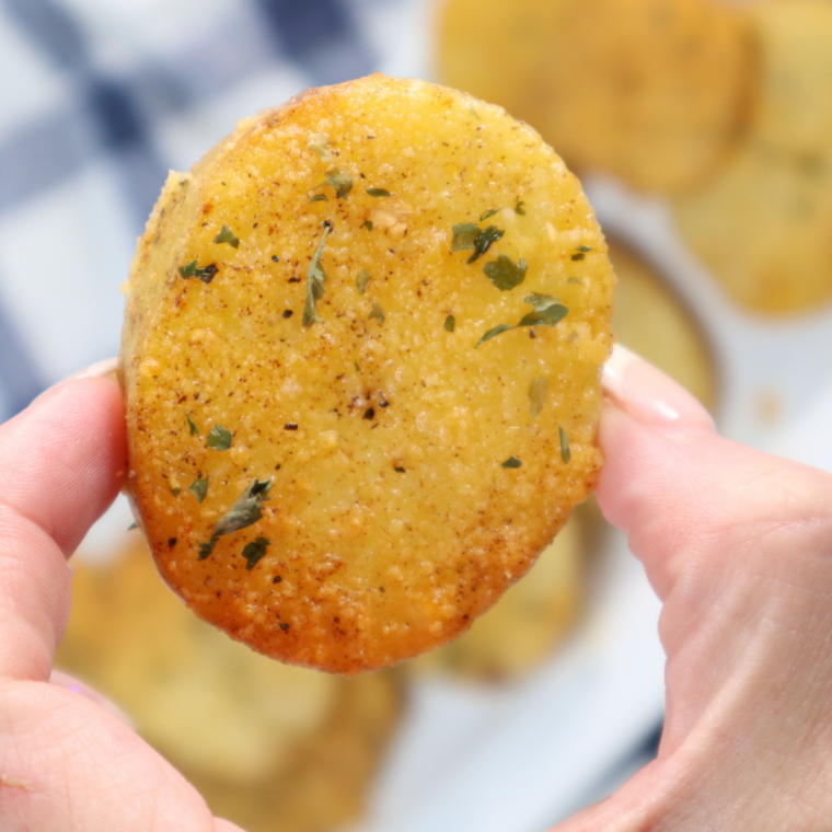 Close-up of Parmesan crusted air fryer potatoes with crispy browned edges