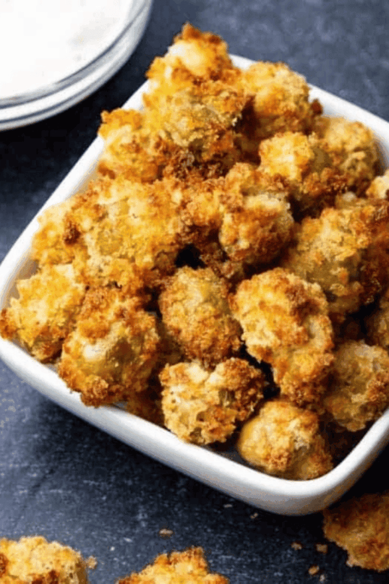 Golden, crispy air fryer fried olives served in a small bowl, ready to enjoy as a snack or appetizer.