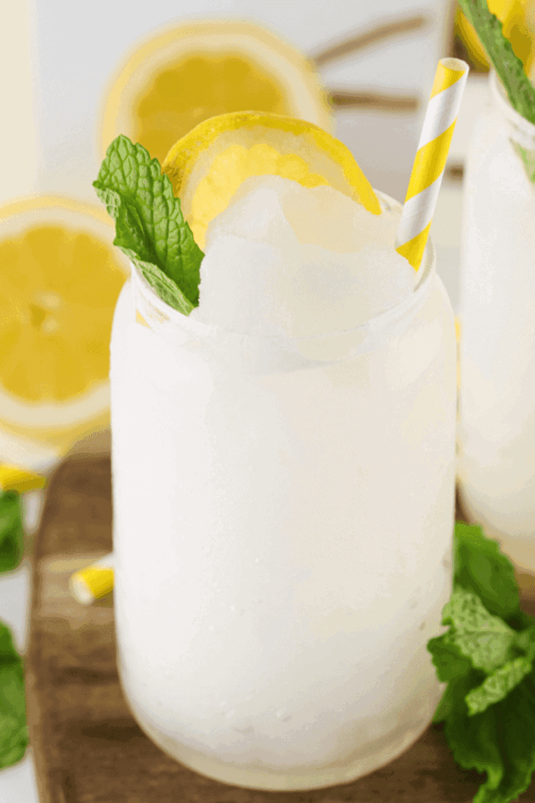 Icy Ninja Creami lemonade slushi served in a glass with lemon slices