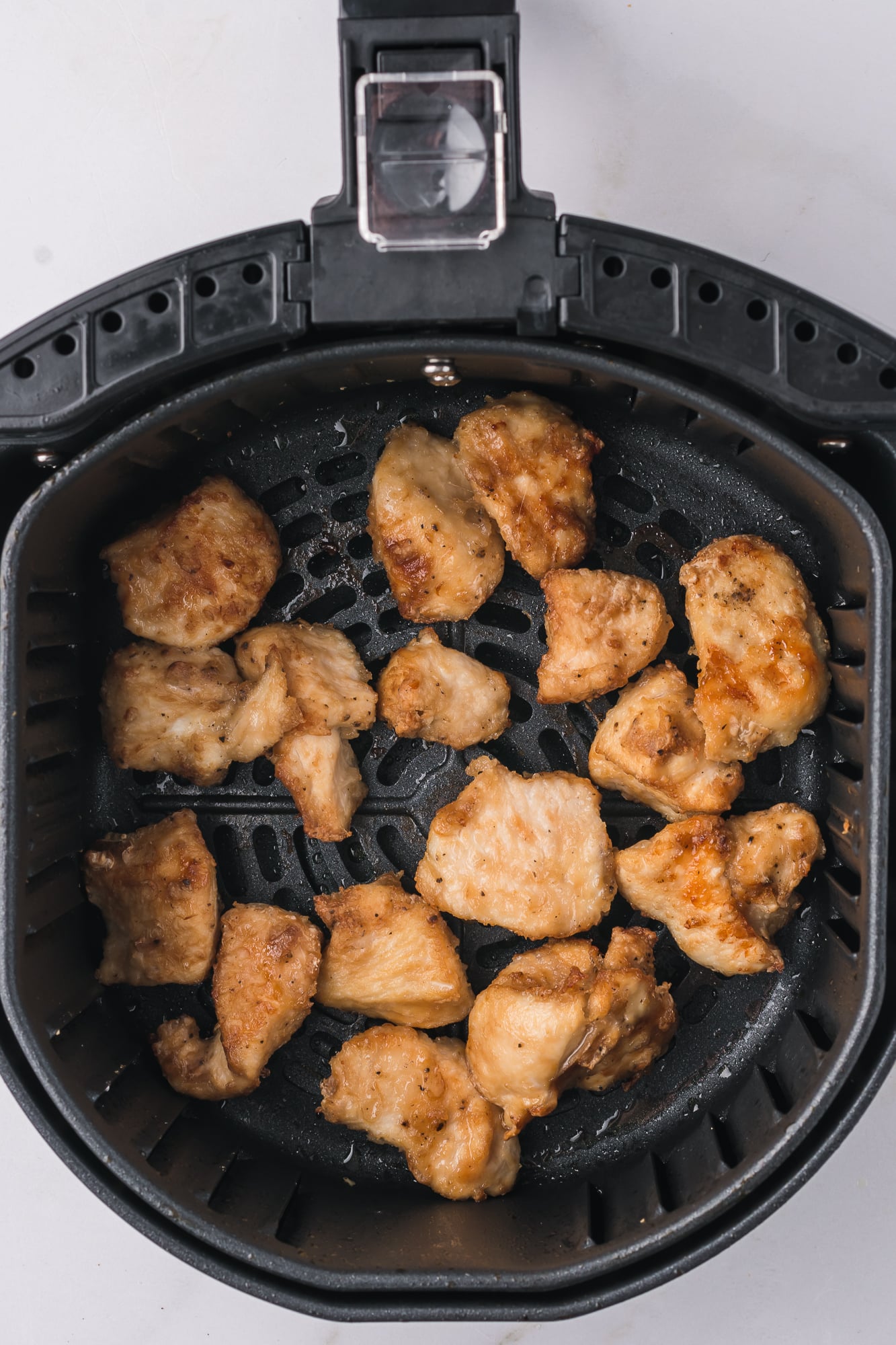 Juicy Air Fryer Copycat Qdoba Chicken served on a plate with fresh toppings.