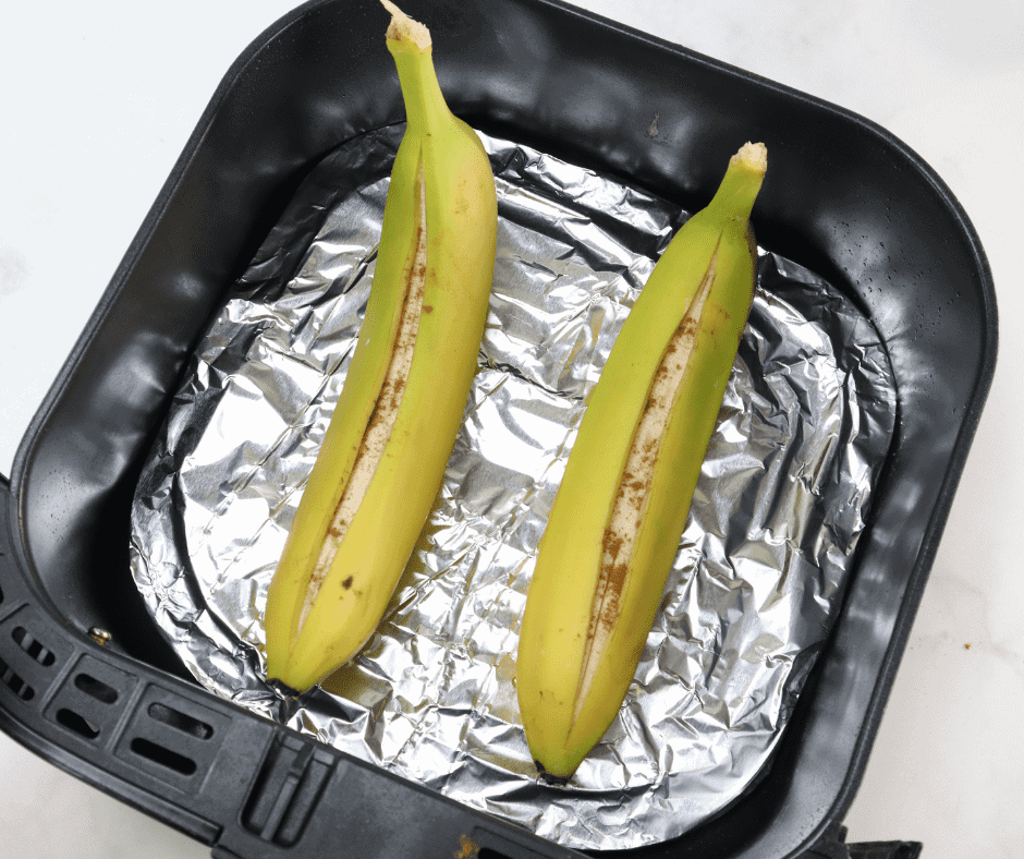 overhead: unripened bananas in the air fryer basket