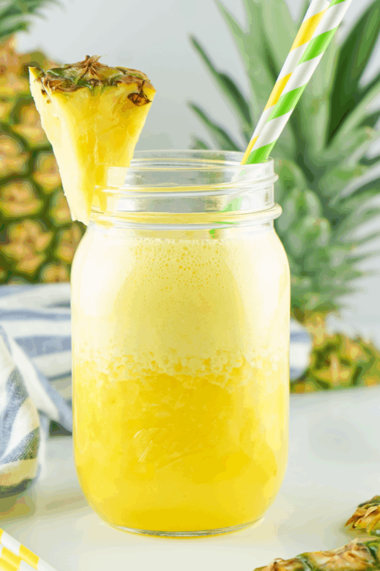 Frozen Ninja Creami pineapple agua fresca served in a glass with ice and pineapple garnish