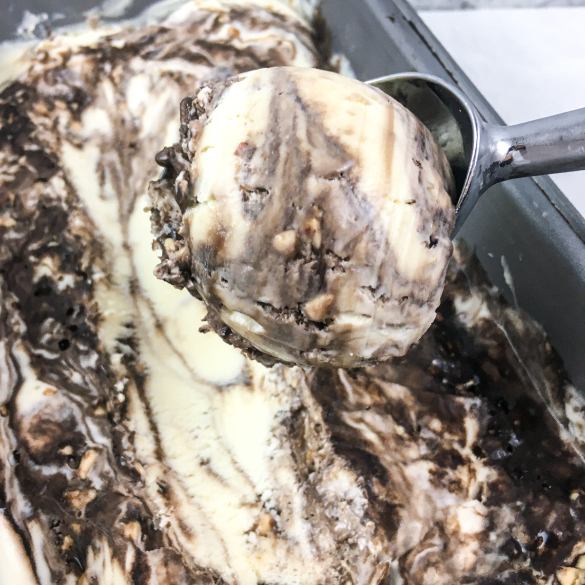 Creamy homemade toffee ice cream made in the Ninja Creami, with swirls of caramel and crunchy toffee bits.