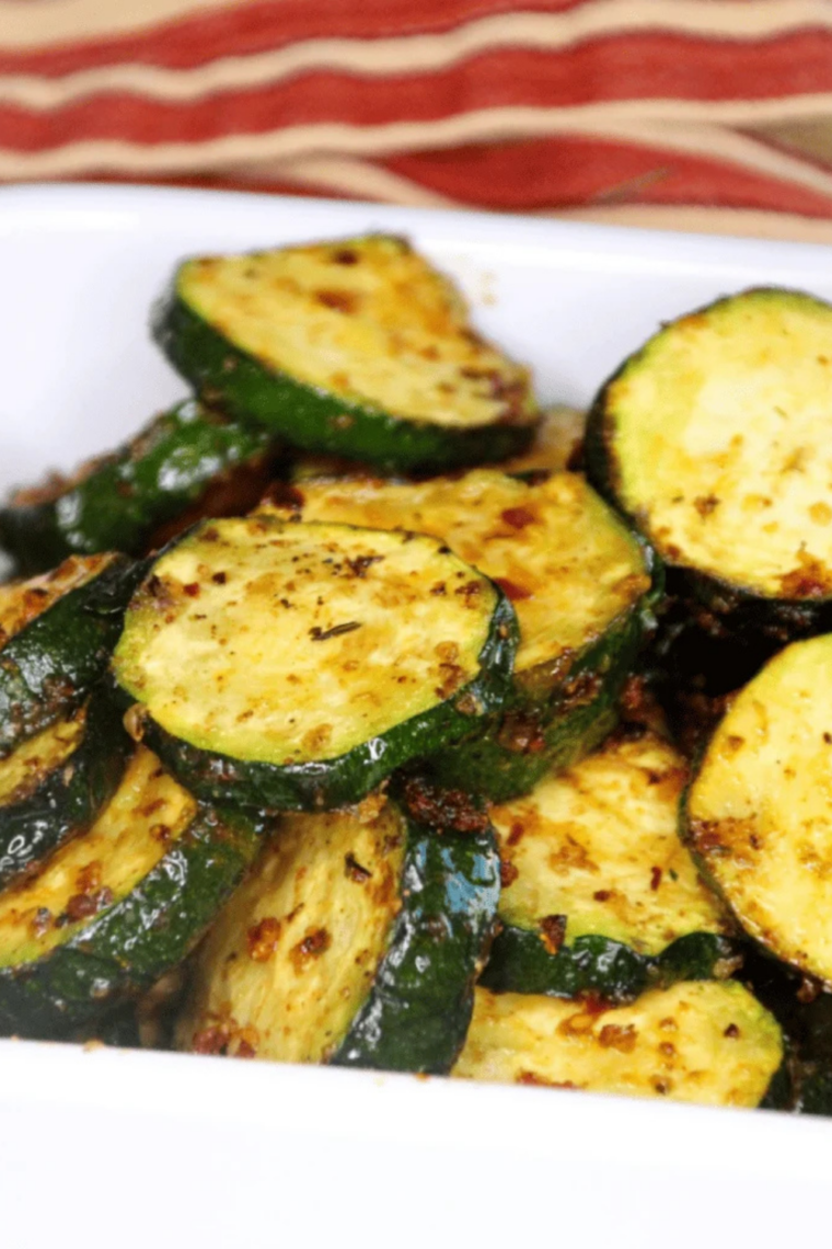 Close up of Ninja Foodi grilled zucchini with golden grill marks and herbs on top