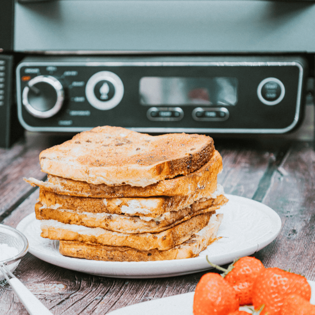 Golden French toast cooked on Ninja Woodfire Grill, served with syrup and fresh berries.