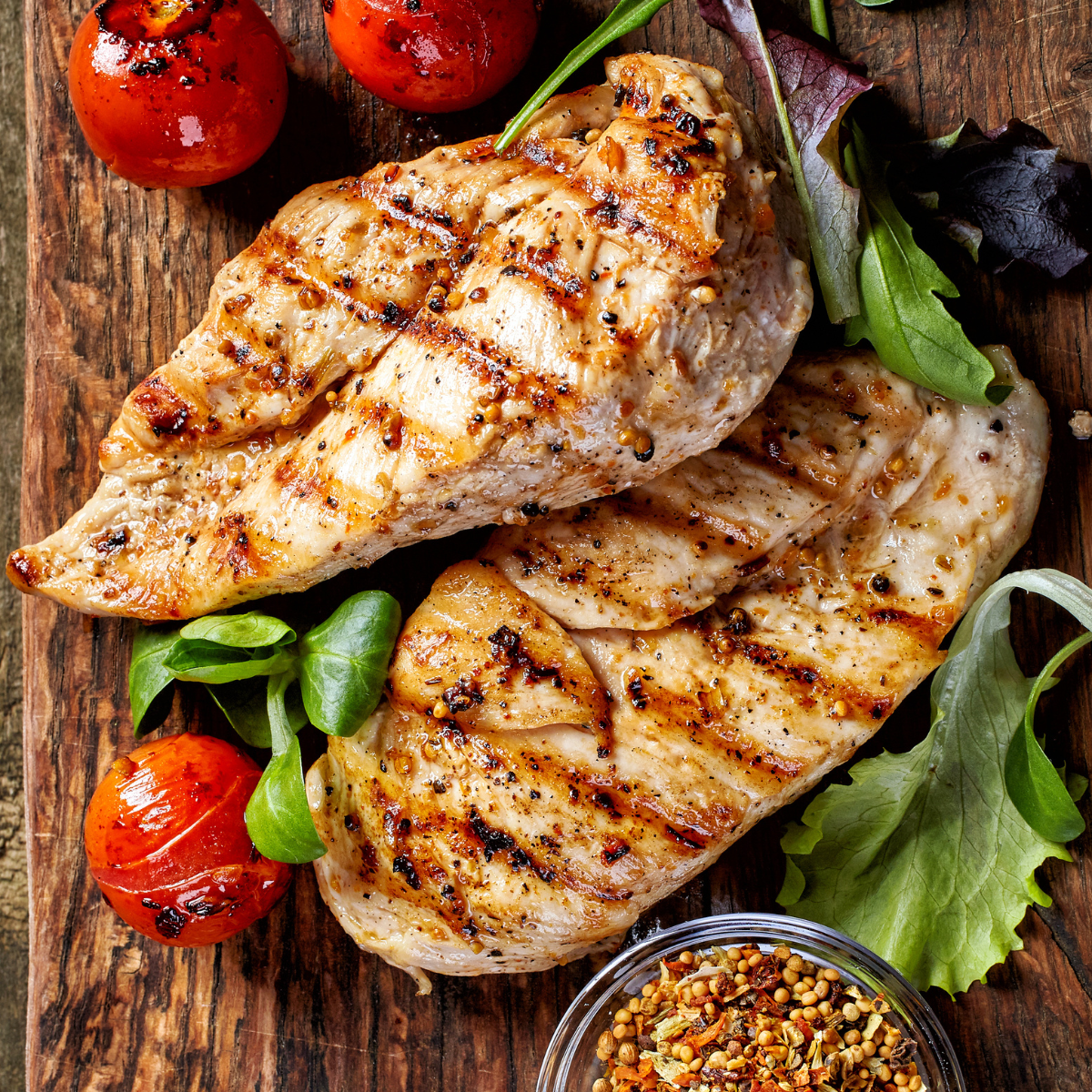 Juicy Ninja Woodfire Grill Chicken Breast served on a plate, garnished with fresh herbs and accompanied by a side of grilled vegetables.