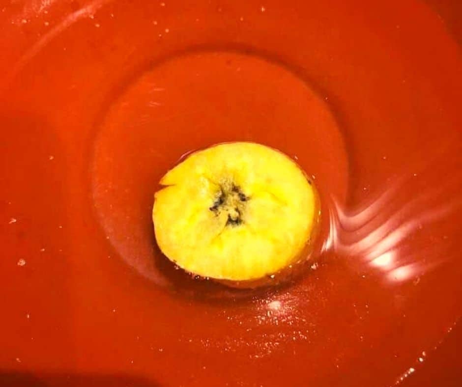 overhead: soaking plantain in water and salt in a red bowl