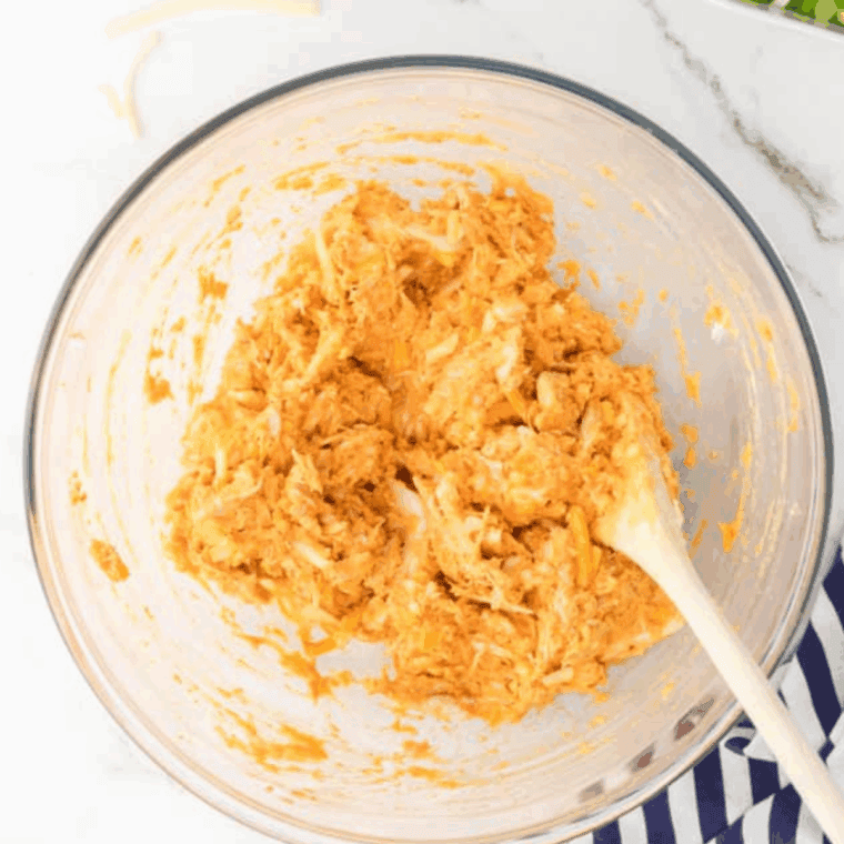 Shredding air fryer chicken breasts with two forks to make buffalo shredded chicken