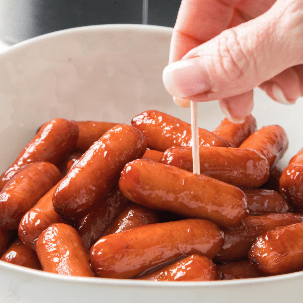Air Fryer Cocktail Franks are bite-size savory treats that can be enjoyed as party appetizers or snacks alongside your favorite sauces, condiments, and other assortments of delicious finger foods! Cooking the cocktail franks in the air fryer offers the perfect environment for these simple snacks to turn a crispy golden brown while remaining juicy, soft, and creamy inside. As soon as you have one, you’ll be reaching for more!