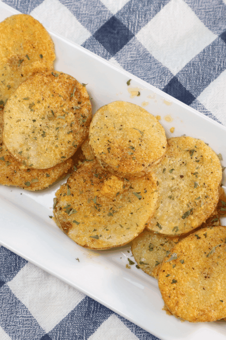 golden brown air fryer cottage fries served in a bowl with herbs