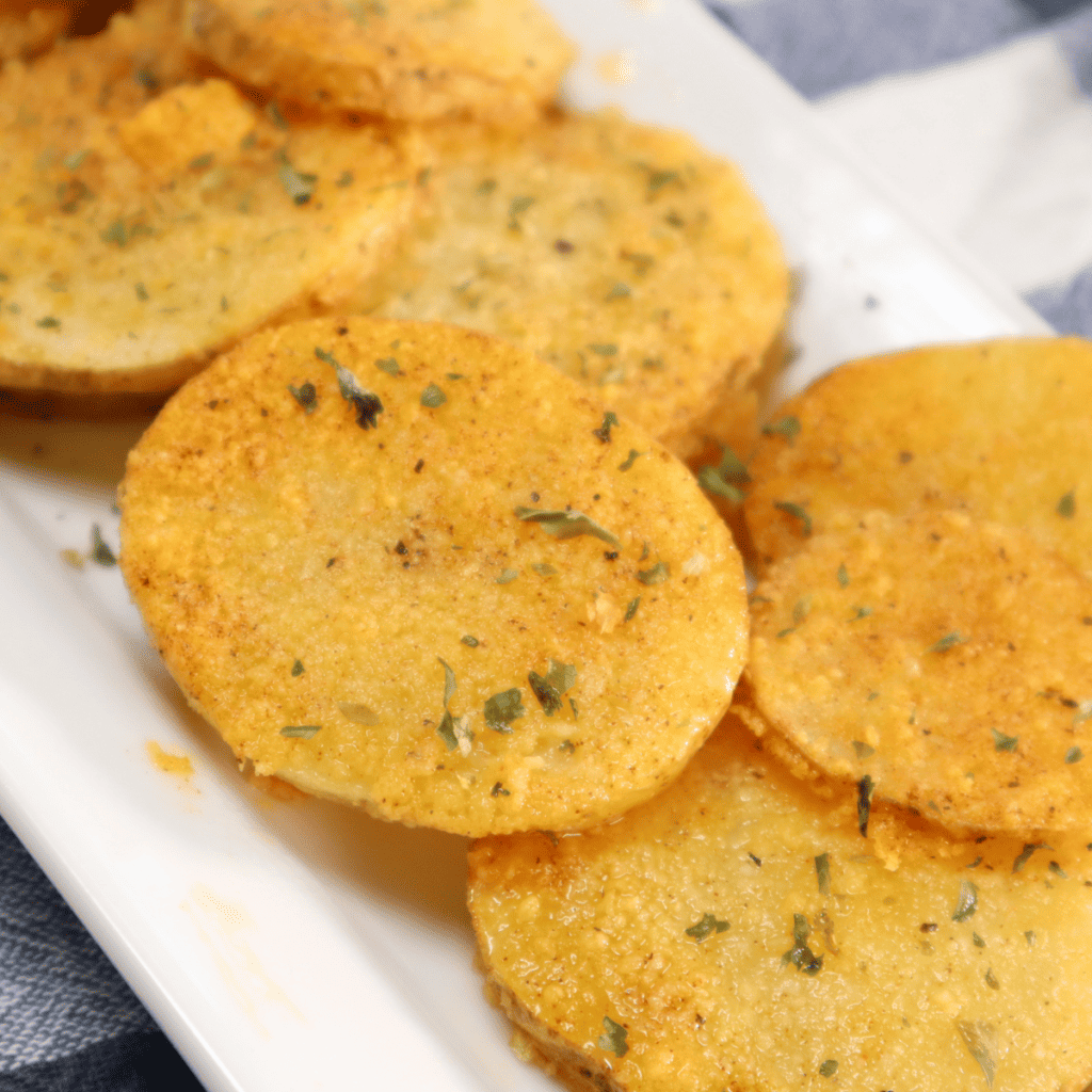 A plate of golden, crispy Air Fryer Cottage Fries, served with a dipping sauce.