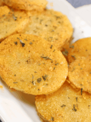 A plate of crispy, golden Air Fryer Cottage Fries, served with a dipping sauce.