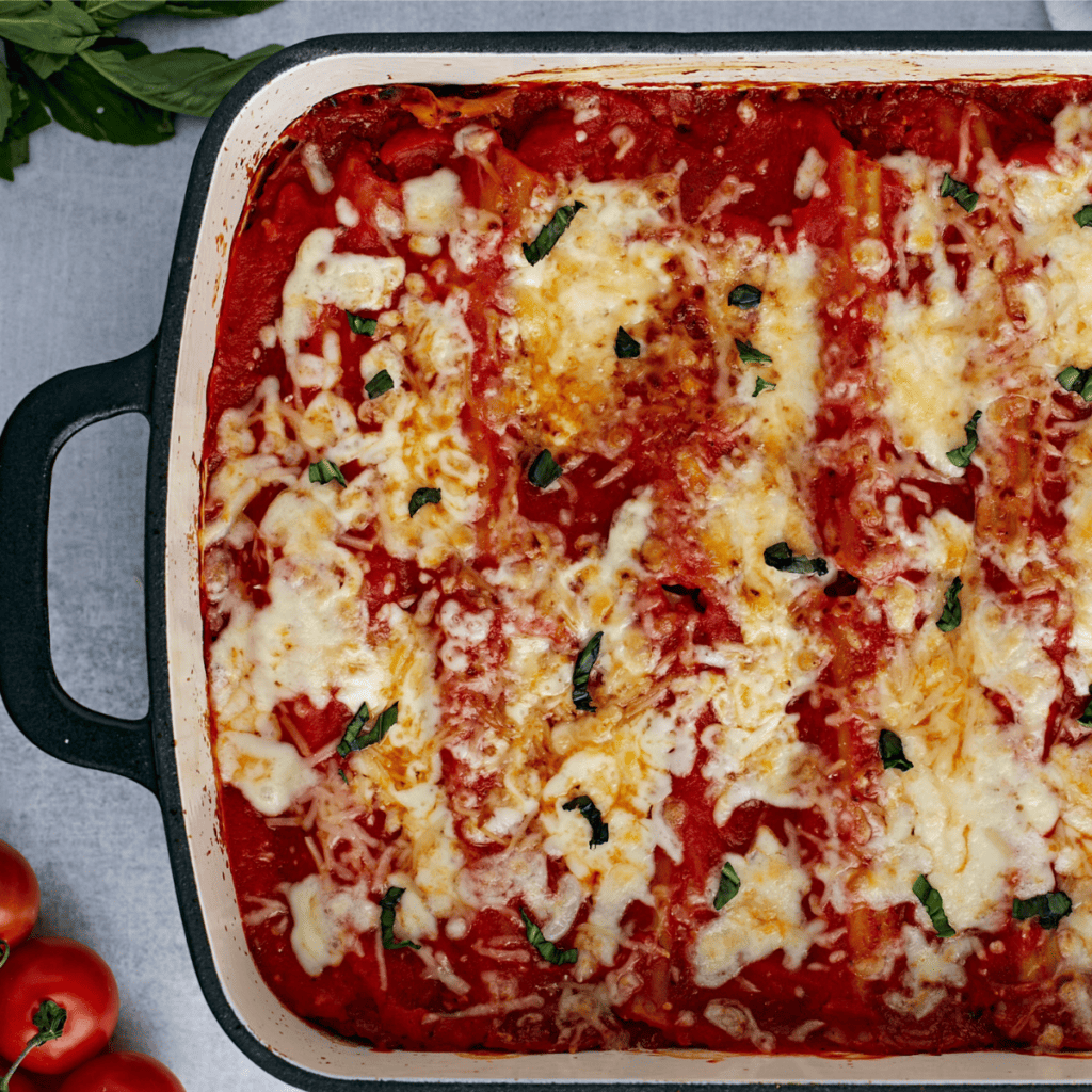 Golden, cheesy air fryer manicotti topped with marinara sauce and melted mozzarella