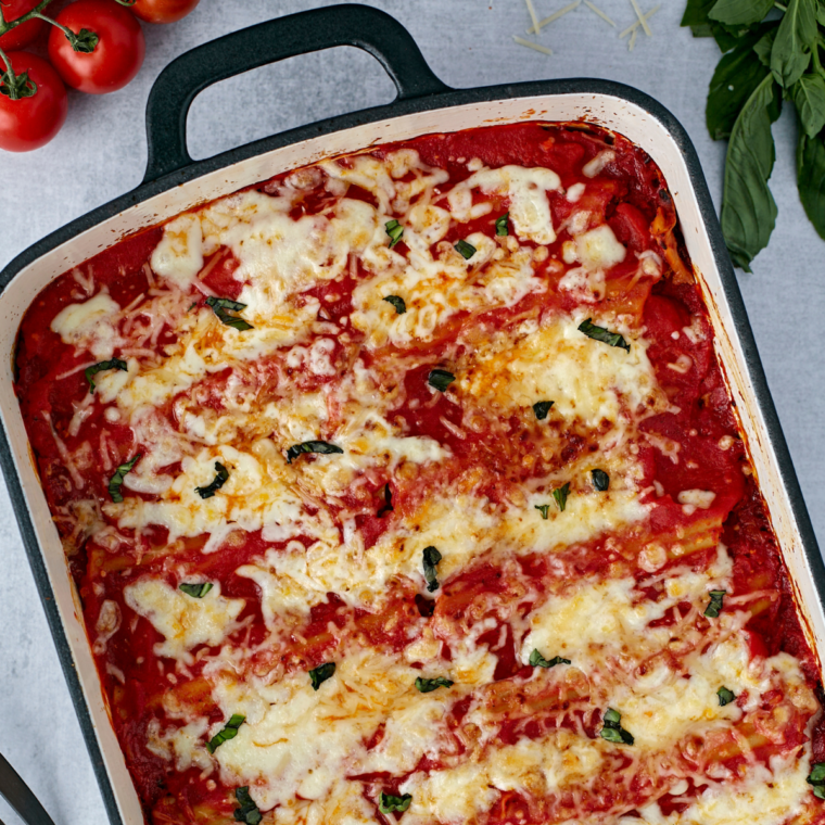 Golden, cheesy manicotti cooked in the air fryer, topped with marinara sauce and melted cheese