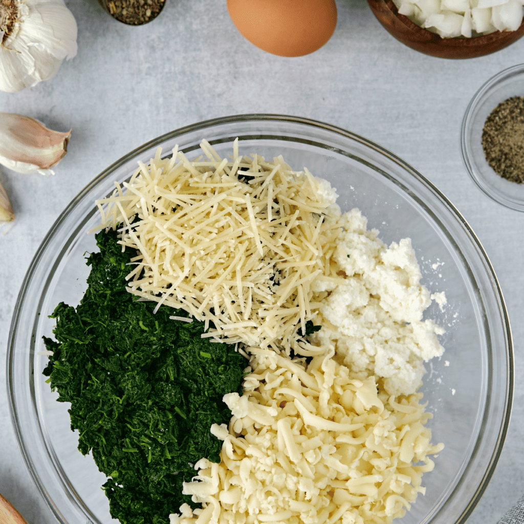 Cooking manicotti pasta tubes in boiling salted water until al dente, then draining