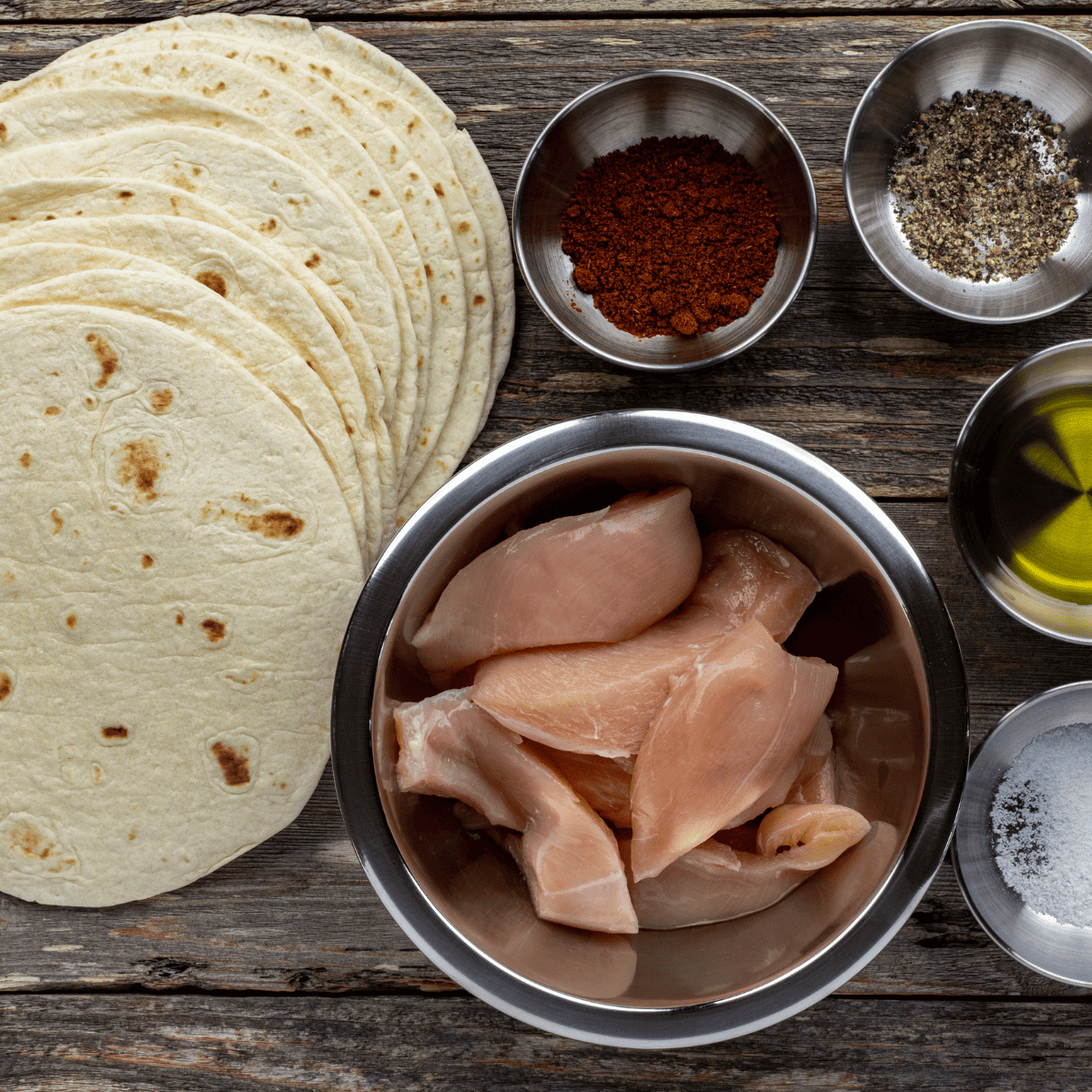 Ingredients for air fryer chicken street tacos: chicken, taco seasoning, lime, corn tortillas, onion, and cilantro