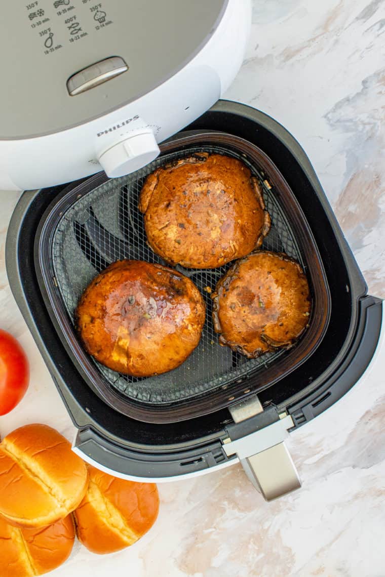 Place marinated portobello mushrooms cap-side down in air fryer basket.