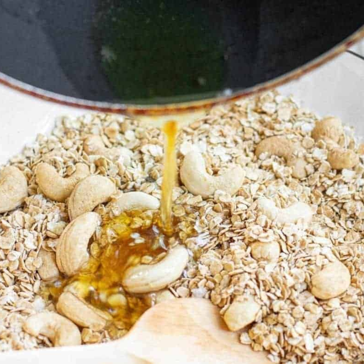 Pumpkin spice granola mixture tossed with maple syrup and coconut oil before air frying