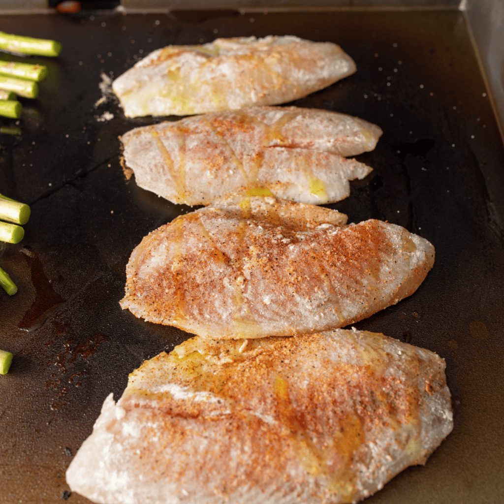 Seasoned catfish fillets searing on the Blackstone griddle
