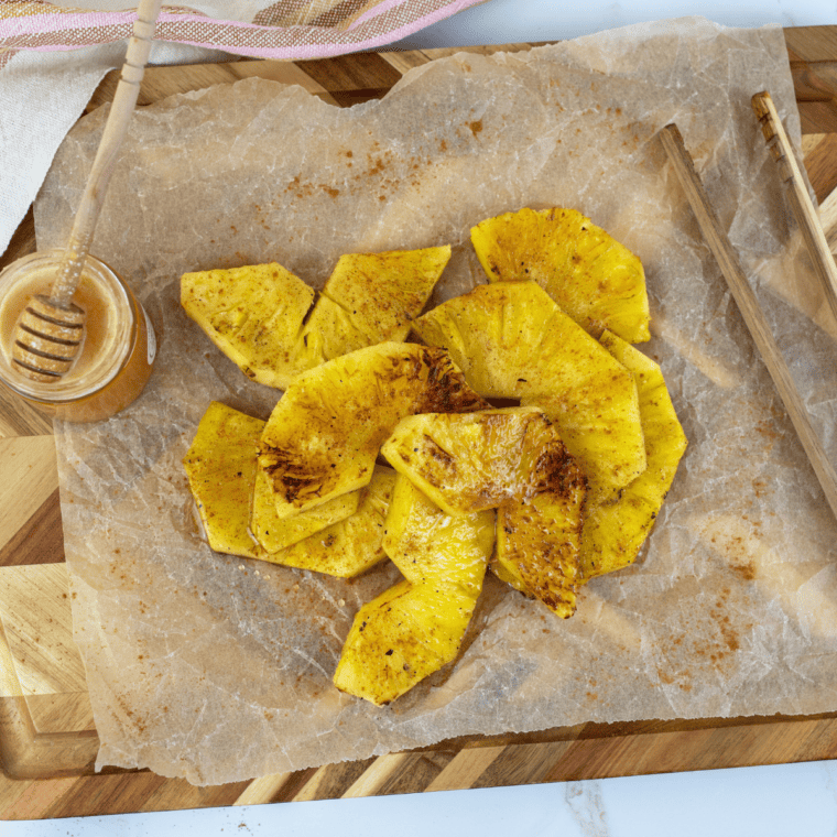 Fresh pineapple slices caramelized on a Blackstone griddle, golden and juicy