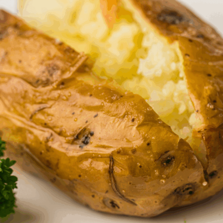 Cheddar’s Scratch Kitchen Baked Potato Recipe on kitchen table, ready to be loaded with toppings.