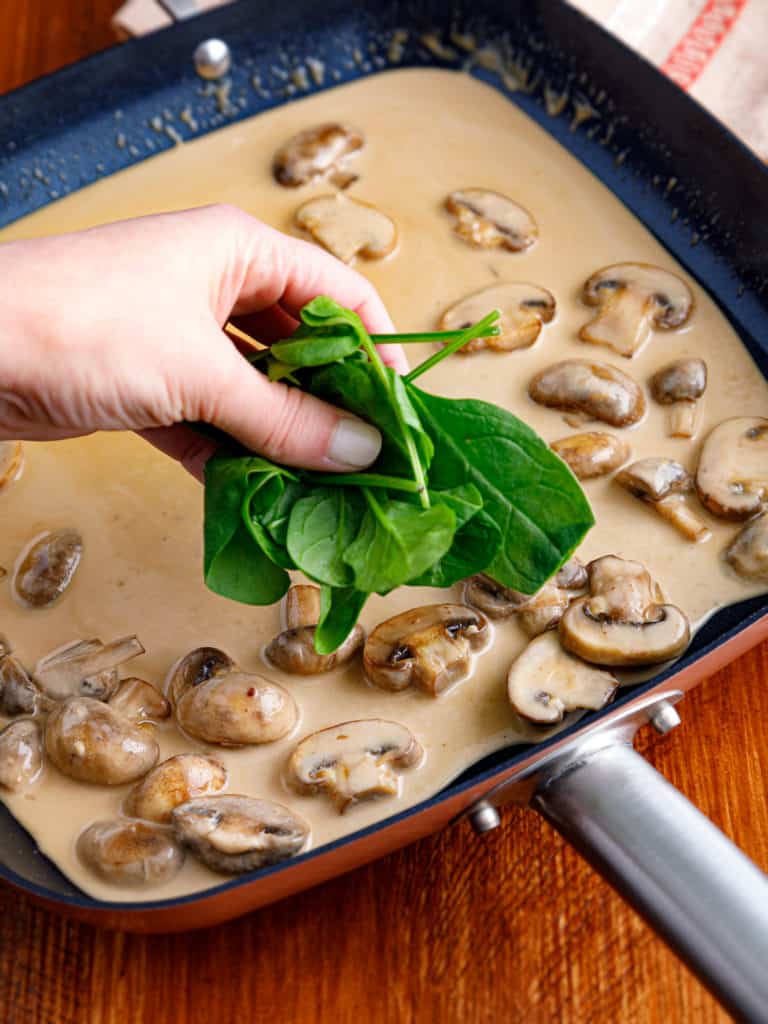 Pouring Marsala wine into the skillet to create the rich sauce for Chicken Marsala.