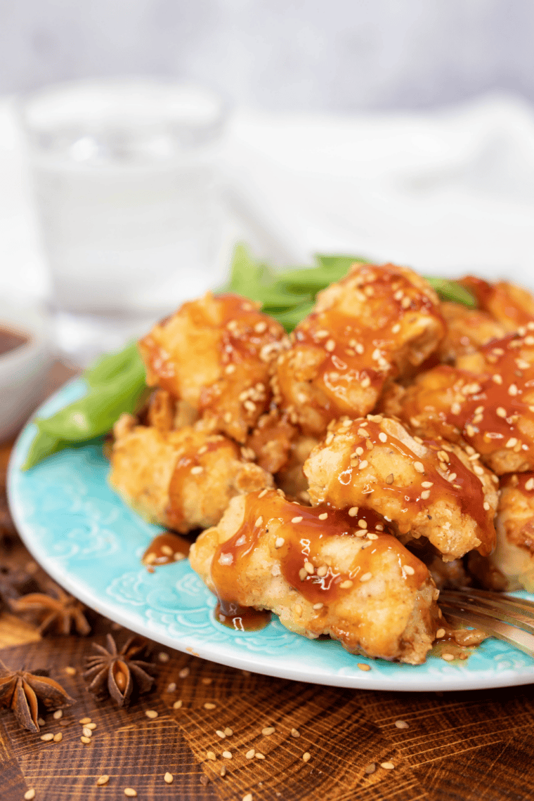 Homemade McDonald's sweet and sour sauce in a small white dish beside golden chicken nuggets.