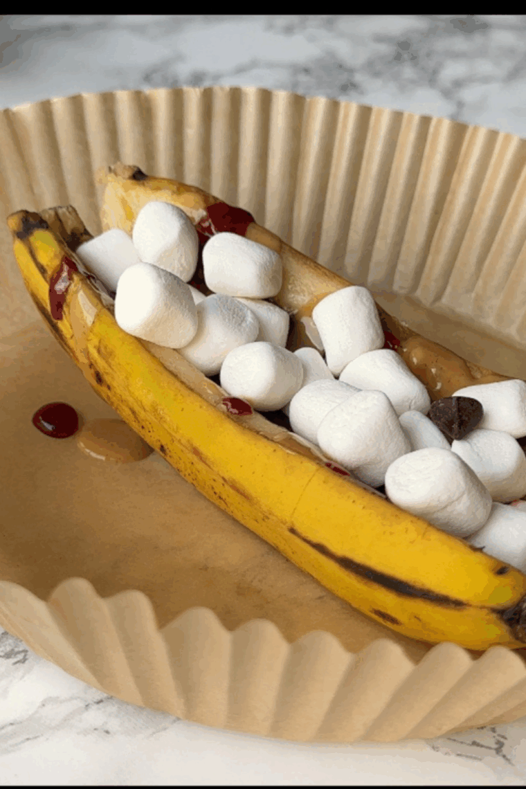 Air fryer banana split with ice cream, caramelized bananas, and toppings
