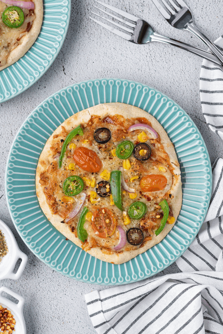 Crispy air fryer pita pizza topped with lean meats, fresh veggies, and melted cheese.