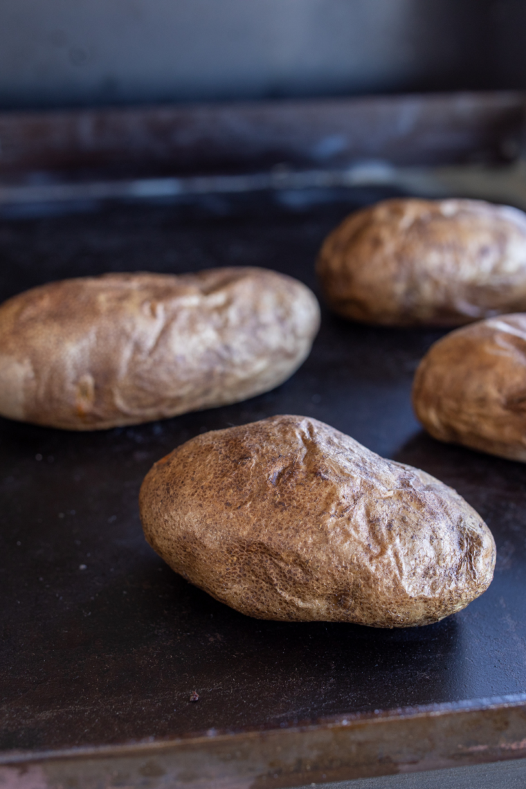 Place Potatoes on Griddle: “Potatoes arranged on Blackstone griddle with space for even cooking