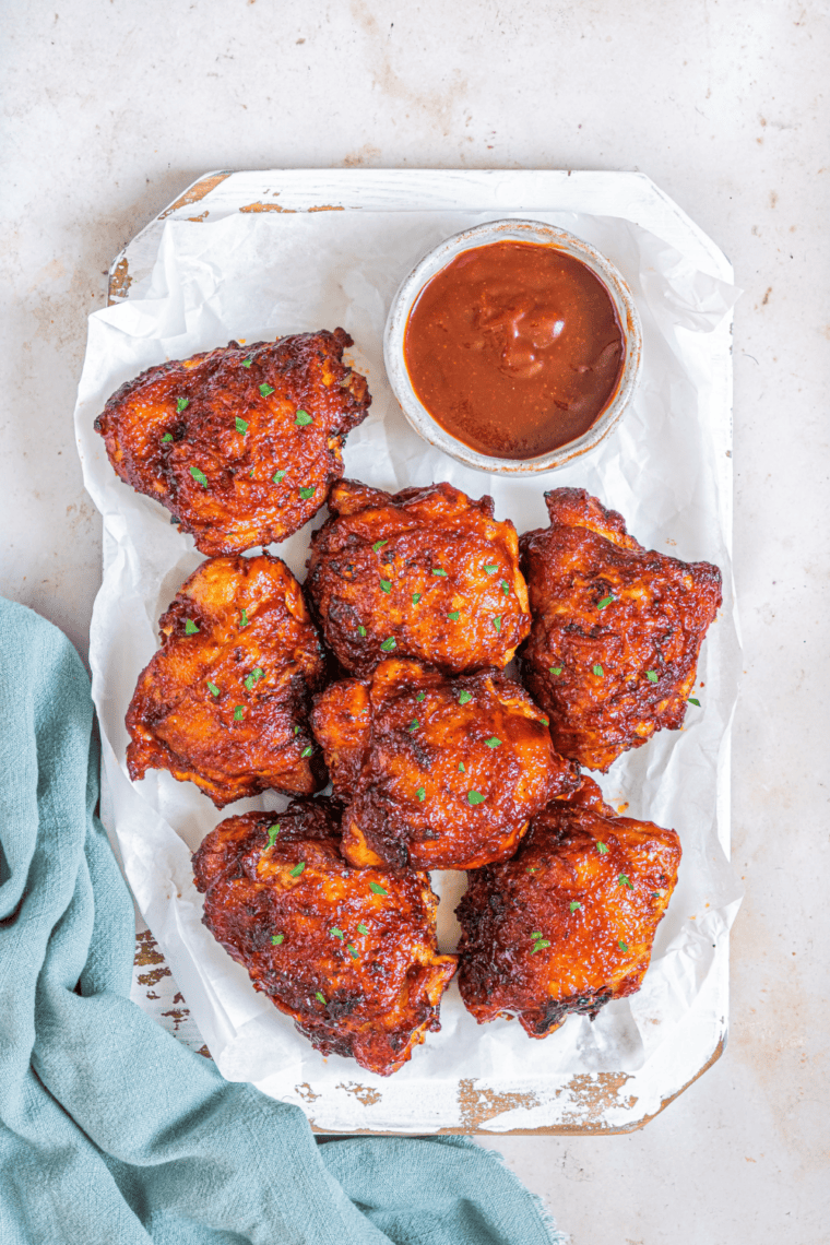 Air fryer cooking frozen boneless skinless chicken thighs for a quick and juicy meal.