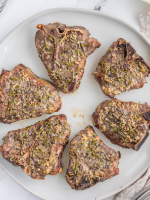 Reheated lamb chops served on a white plate
