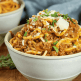 Bowl of spaghetti and meatballs made in Ninja Speedi with rich tomato sauce and parmesan