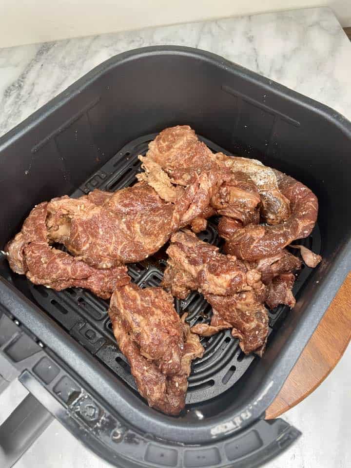 Cooking Process - The air fryer with Trader Joe's Bool Kogi cooking inside, illustrating the cooking process and the sizzling sound of the beef.