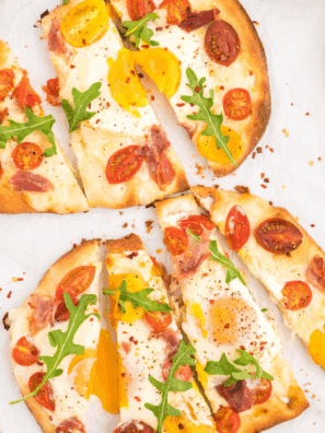 Air Fryer Breakfast Flatbread Pizza topped with eggs, cheese, and veggies.