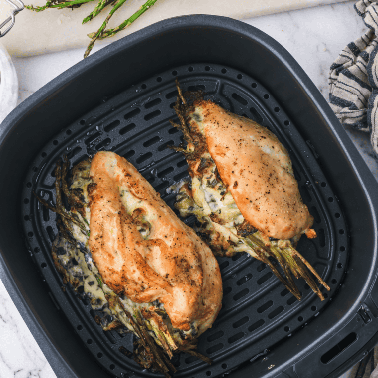 Spicy variation of air fryer artichoke stuffed chicken topped with melted Parmesan cheese