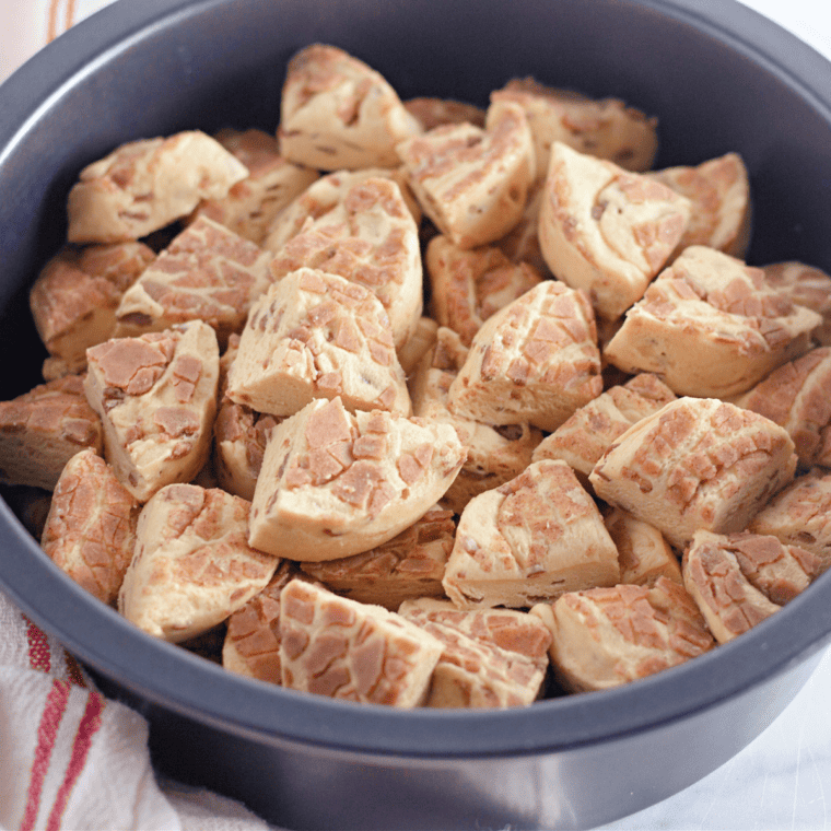 Place the diced cinnamon rolls into the bottom of the baking pan. 