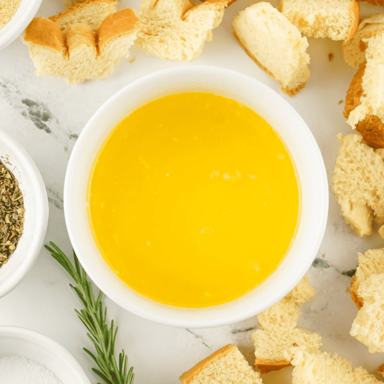 Cubed bread pieces tossed in olive oil and seasonings for making croutons.