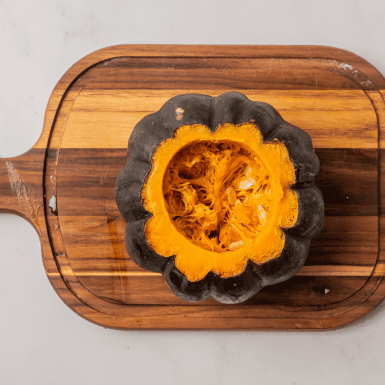 Scooping out seeds from the kabocha squash halves.