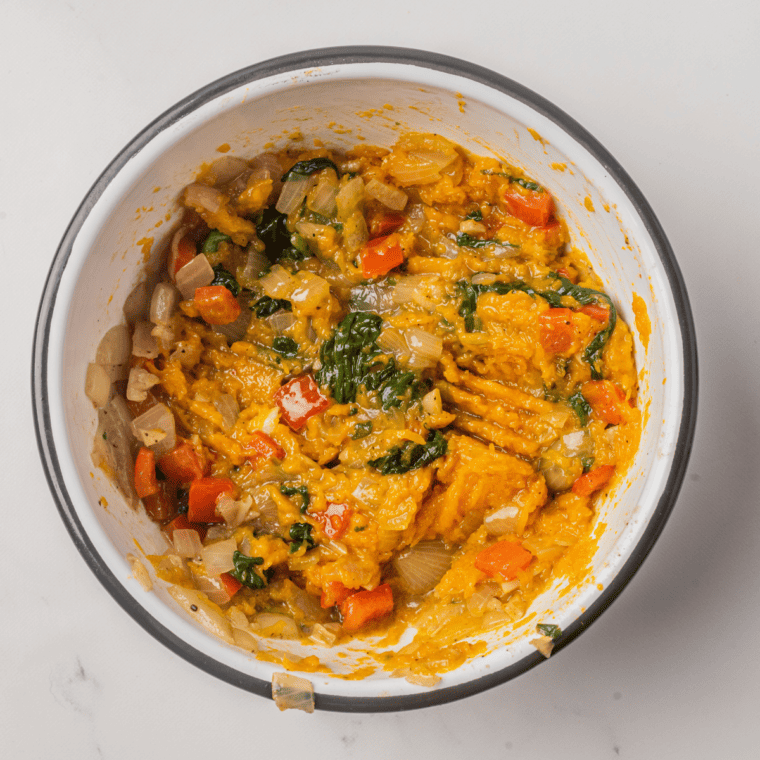 Stuffing the cooked kabocha squash with a savory filling.