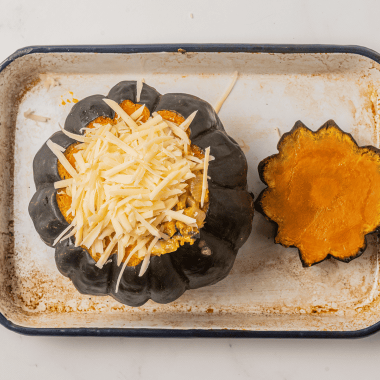 Stuffing the cooked kabocha squash with a savory filling.