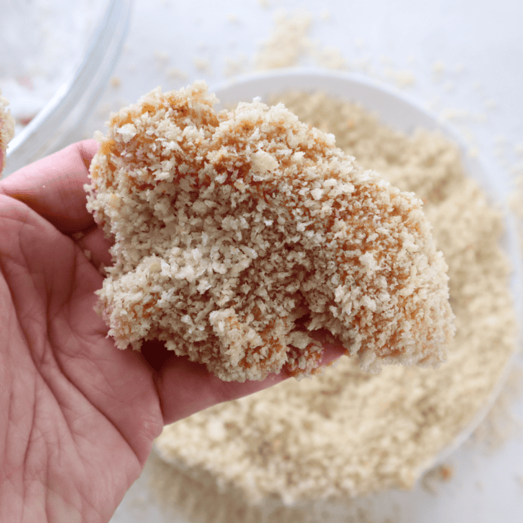 Breaded lemon pepper chicken tenders arranged in a single layer in the air fryer basket