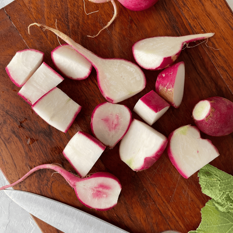 Trimmed and halved radishes ready to be seasoned for air frying.