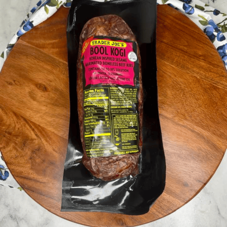 Before Cooking - A package of Trader Joe's Bool Kogi opened with marinated beef slices laid out, ready to be cooked in the air fryer.