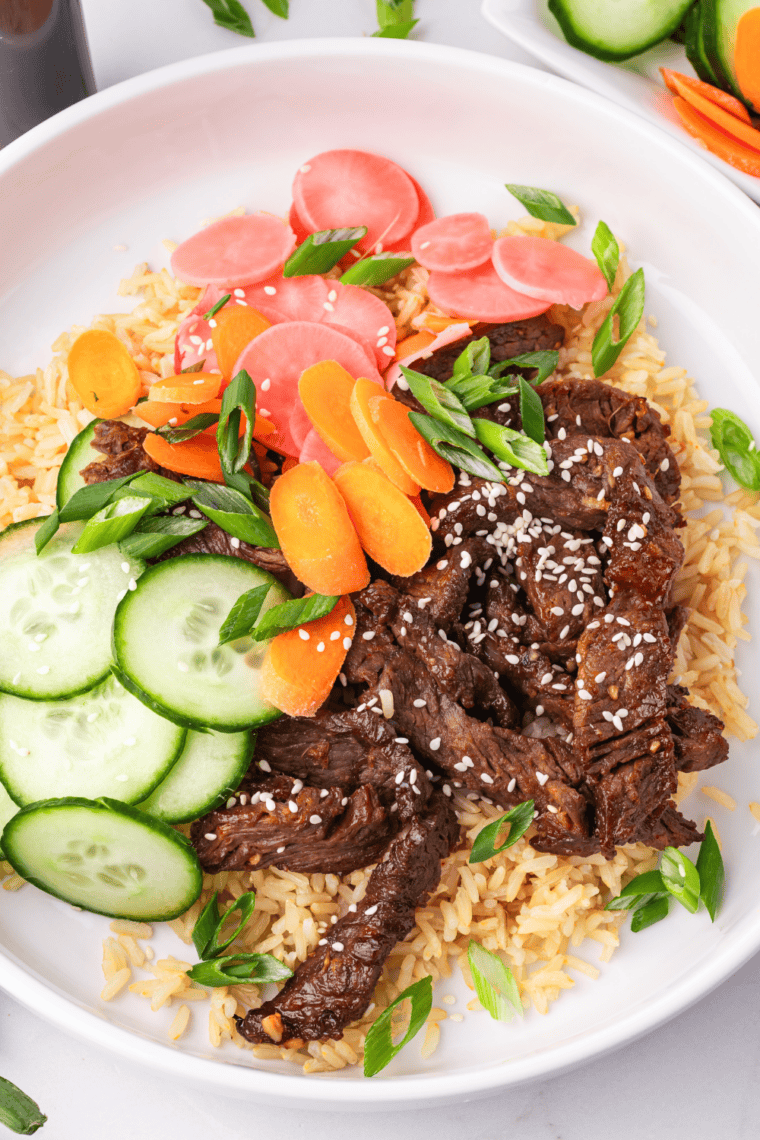 Air Fryer Trader Joe's Bool Kogi served over white rice with sautéed vegetables