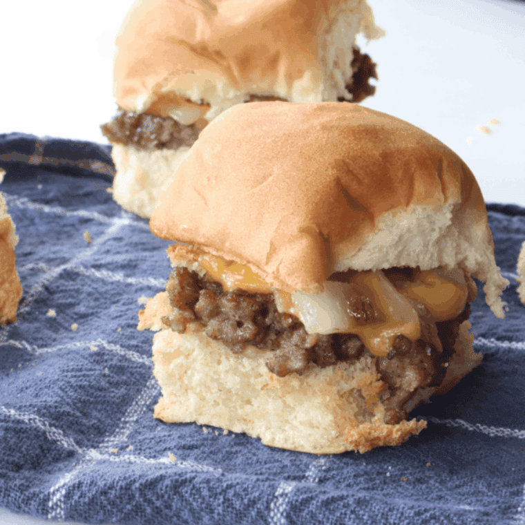 Homemade copycat White Castle burgers with thin beef patties, onions, and soft slider buns on a serving tray.