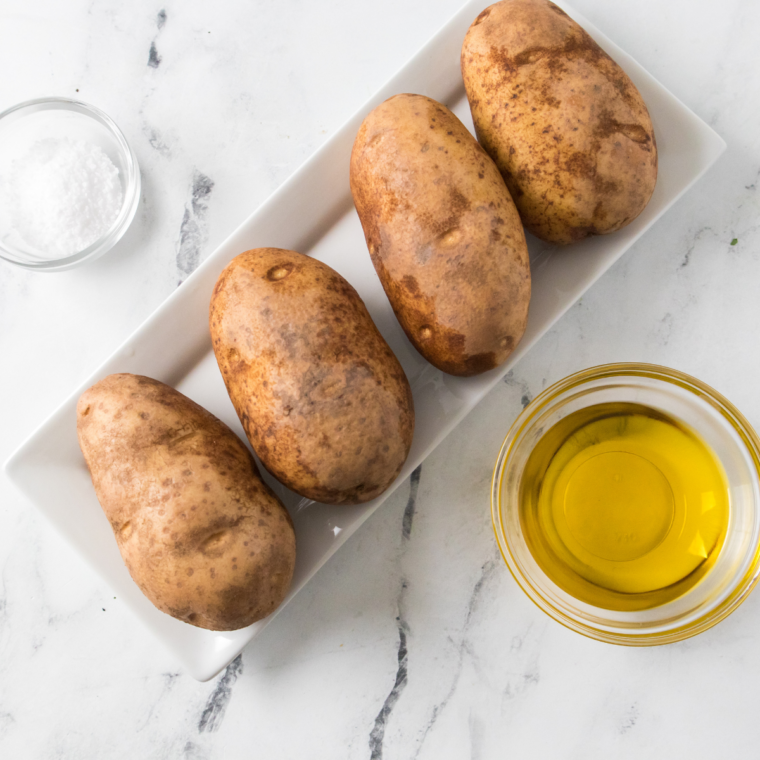 Russet potato pricked with a fork before air frying in the Ninja Crispi