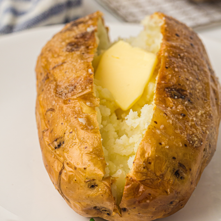 Ninja Crispi baked potato cut open showing fluffy interior and crispy skin