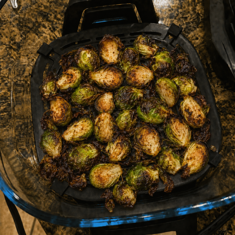 Brussels sprouts tossed halfway through cooking in the Ninja Crispi glass container