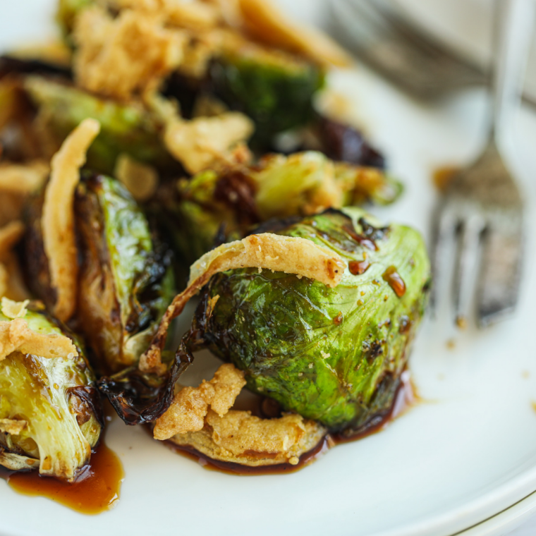 Ninja Crispi Brussels sprouts with crispy bacon on a plate